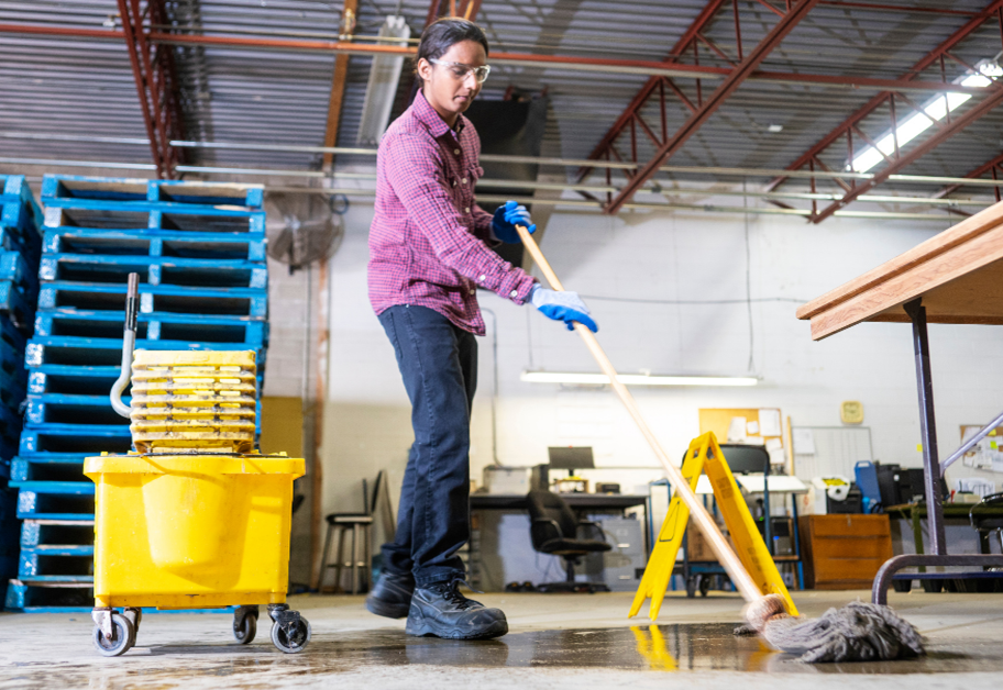 Worker mopping up a spill